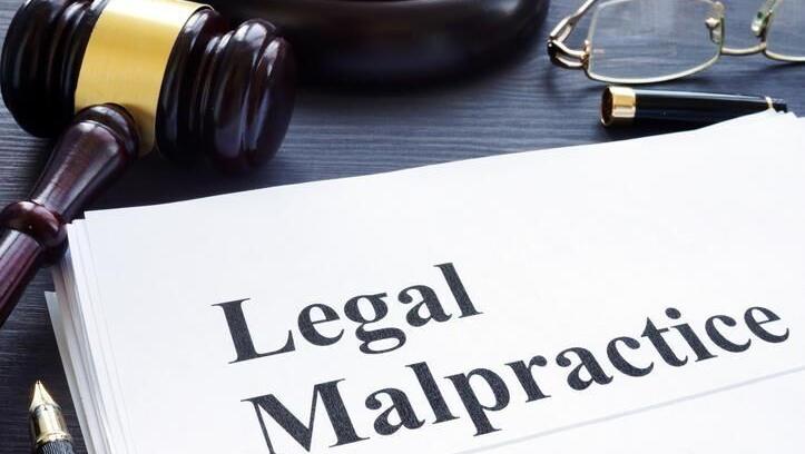 Law firm seeks to remove malpractice case to federal court